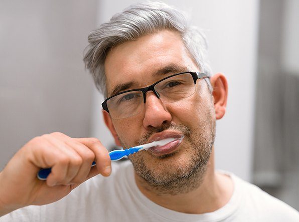 man brushing teeth