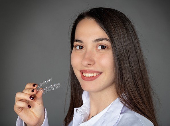 woman holding invisalign tray