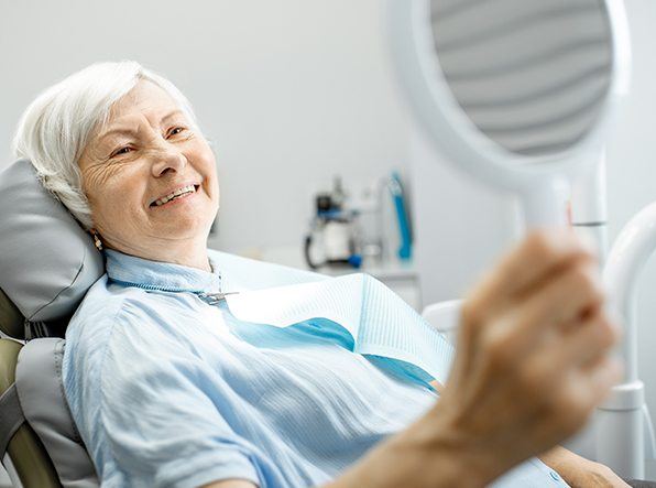 woman smiling in circle mirror