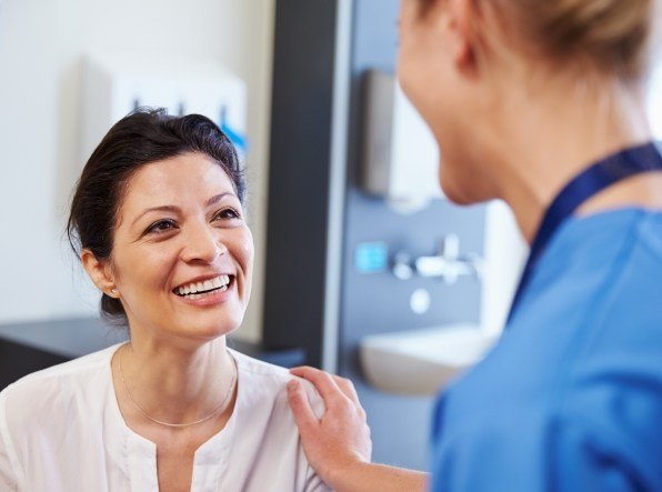 team member holding patients shoulder