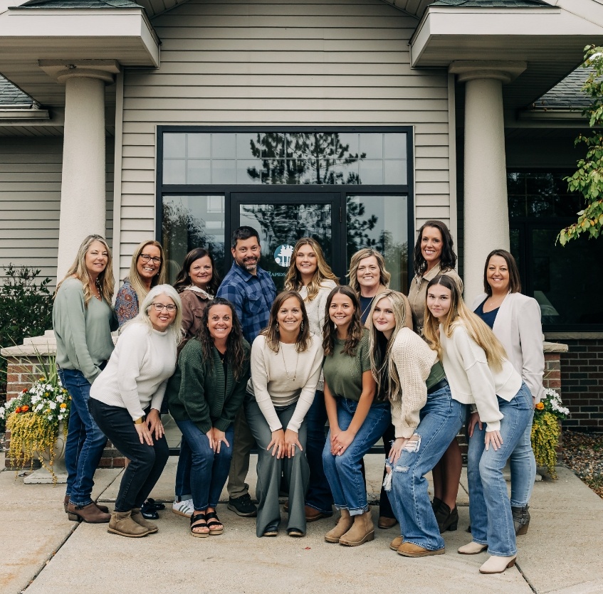 team members in fall leaves