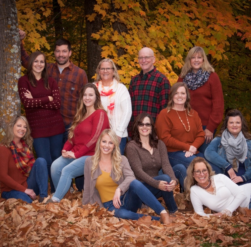 team members in fall leaves