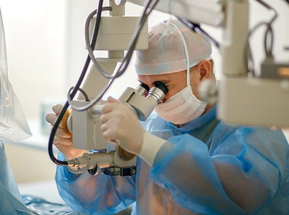 Dentist performing oral surgery