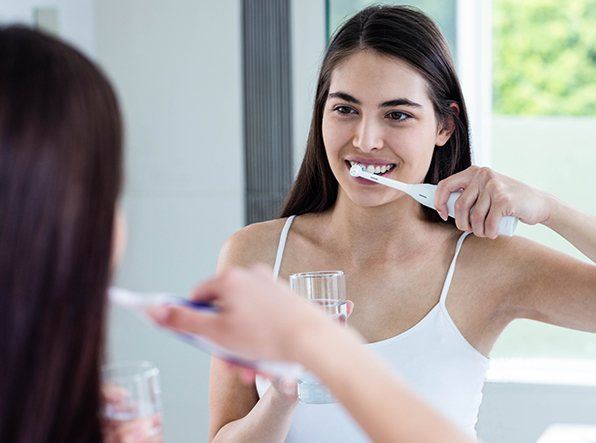 gil brushing teeth in mirror