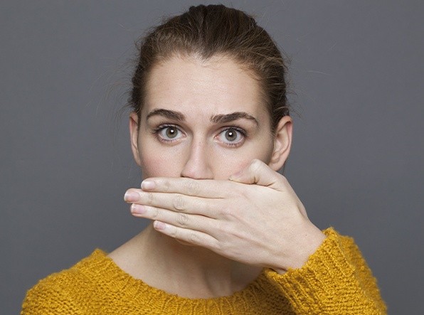 woman covering mouth