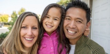 family of three smiling