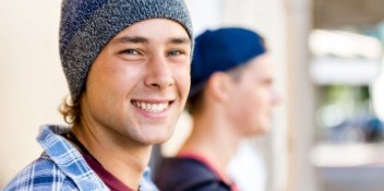 teen with hat on smiling