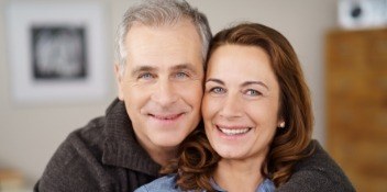 husband and wife smiling side by side