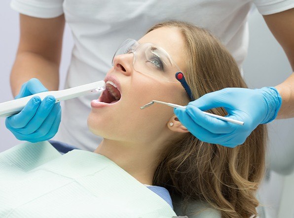 dentist using intraoral camera on woman